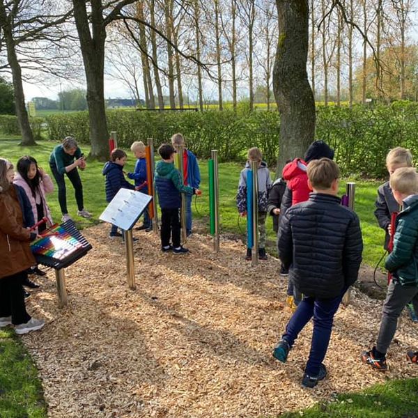 pupils playing their new outdoor musical instruments in a danish school