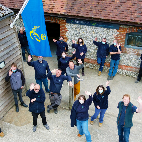 The team from Percussion Play looking up and waving