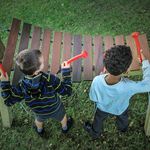 birds eye view of two boys playing a large outdoor marimba in a park