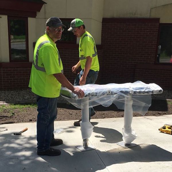 staff at the North Mankato Taylor Library installing new outdoor musical instruments