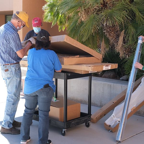 members of the Valle Verde Rotary Club unpacking outdoor musical instruments ready to install