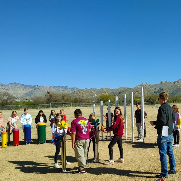 pupils from Tanque Verde School playing large outdoor musical instruments in their new outdoor music classroom