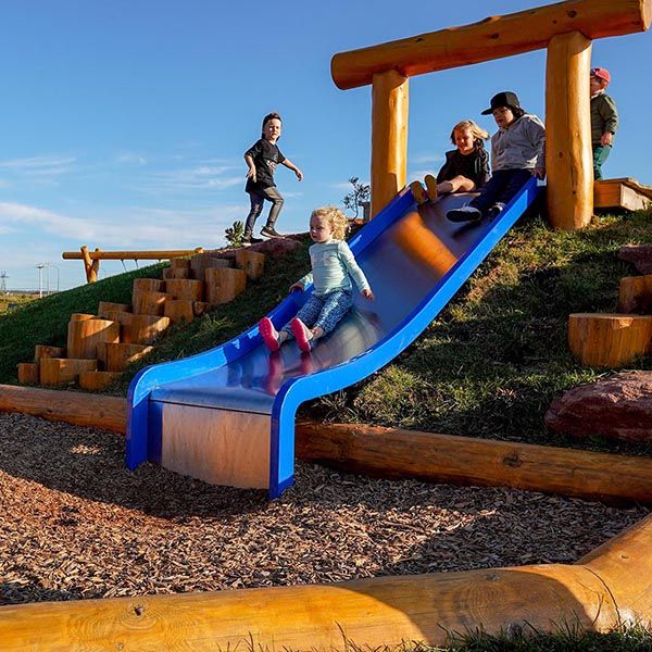 Children on the slide at the new playground at the Fundy Discovery Site