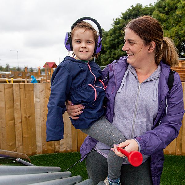 little girl and mother playing a large outdoor musical instrument in the new playground at Greystones Co Wicklow Ireland