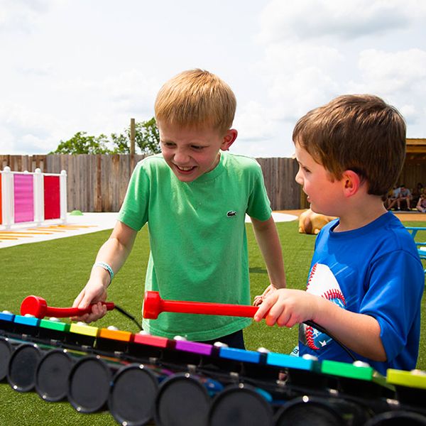 Children playing the outdoor musical instruments in the new playground at the Arc Encounter family attraction