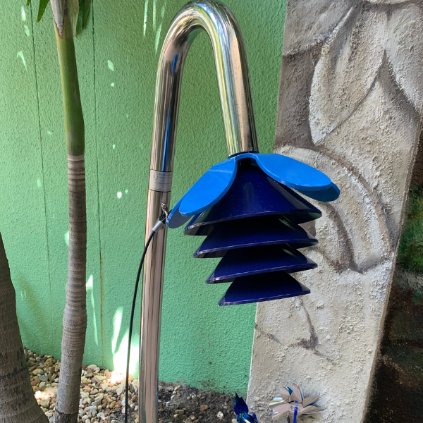 a blue outdoor musical instrument that is shaped like a flower and installed in the healing garden at palm beach children's hospital