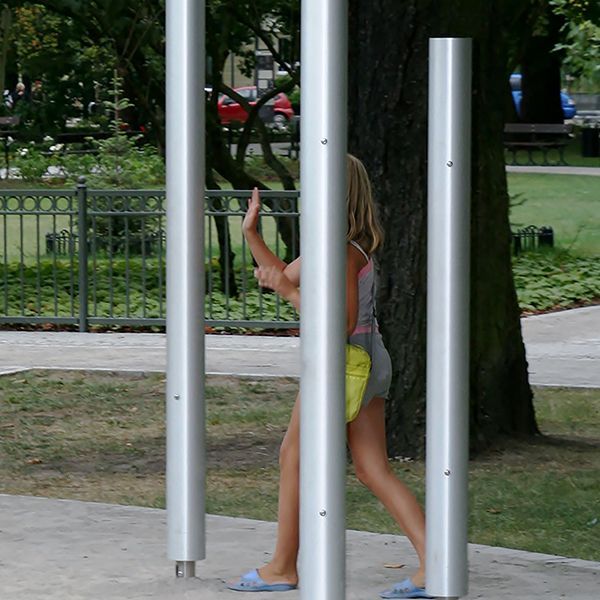 Three silver chimes installed in a children's playground