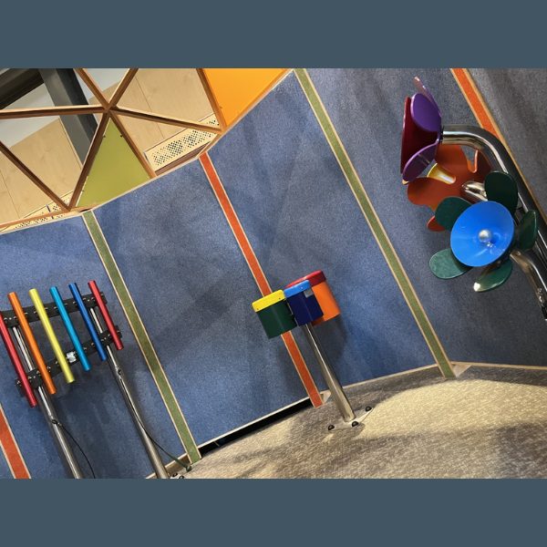 A trio of outdoor musical instruments in rainbow colors in the palo alto museum