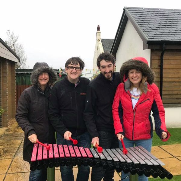 Kier family playing the Duo outdoor xylophone donated to Calums Cabin Isle of Bute 