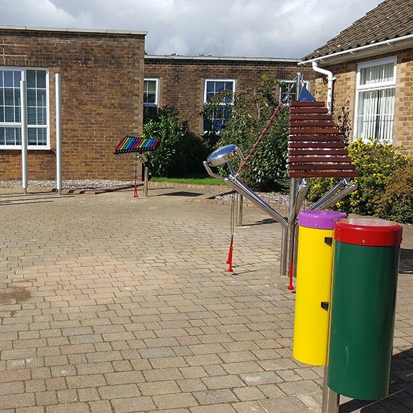 special needs school playground with outdoor musical instruments installed