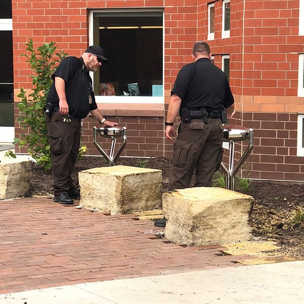 prison wardens at iowa women's prison playing on two stainless steel tongue drums in the new sensory garden