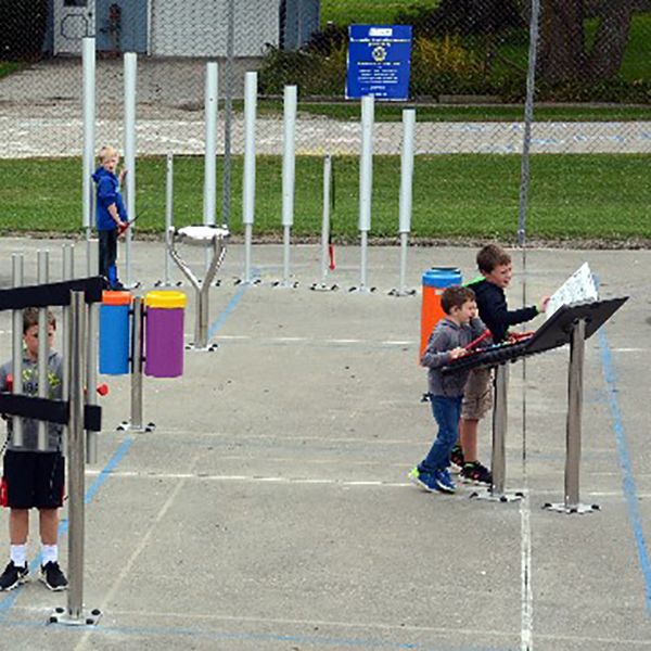 Aerial view of the children playing on the new outdoor musical instruments in the Montezuma elementary School playgrounds