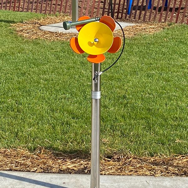 a large yellow metal outdoor musical flower