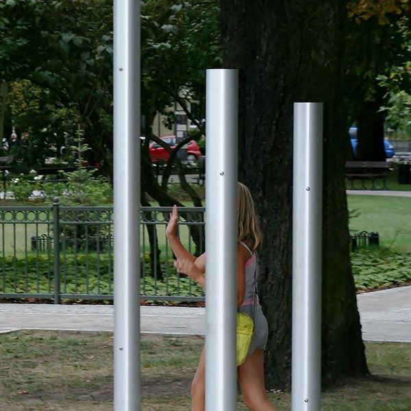 Three silver chimes installed in a children's playground