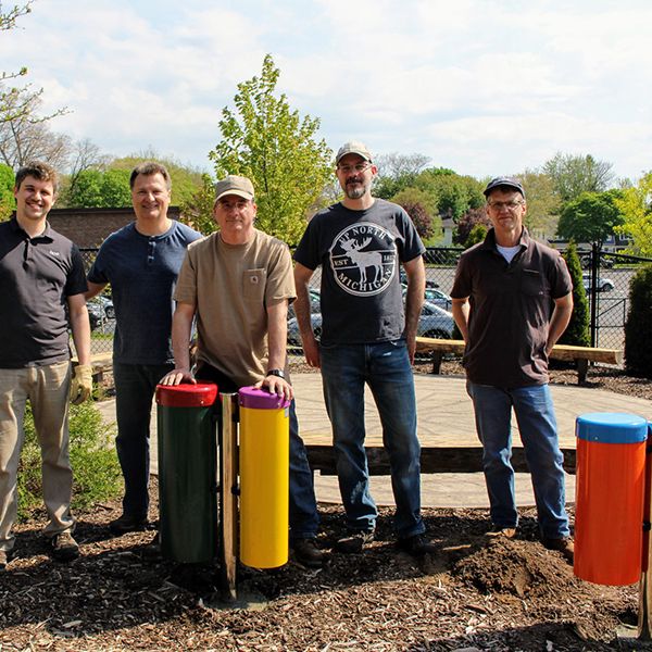 a group of men installing outdoor musical instruments at the Children's healing center