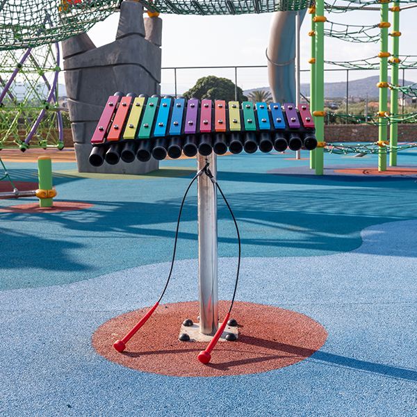 outdoor xylophone with rainbow colored keys and stainless steel post in the Lyttos Beach Resort new playground