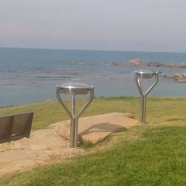 two stainless steel tongue drums installed overlooking the sea in kibbutz