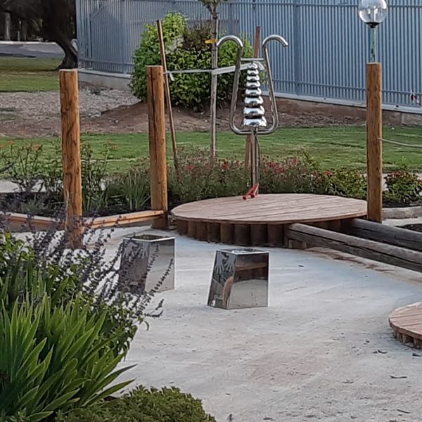 a stainless steel large bell lyre in the outdoor musical playground in Kibbutz Magal