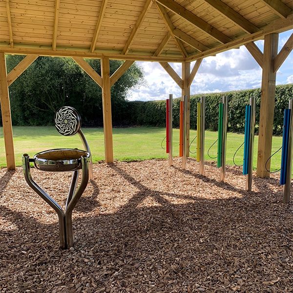 Outdoor musical instruments displayed under a shelter at the Thomas Centre