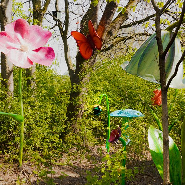 large flower, butterfly and toadstool sculptures with outdoor musical flower bells 