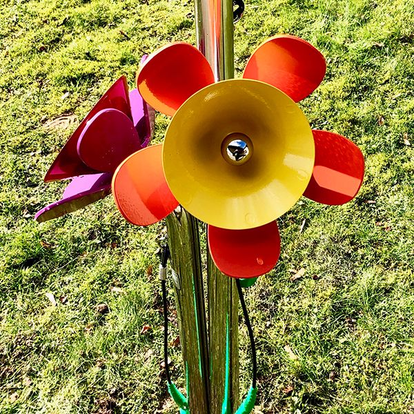 small brightly coloured outdoor musical flowers for residents and passerbys to play on in Hassinghave Carehome 