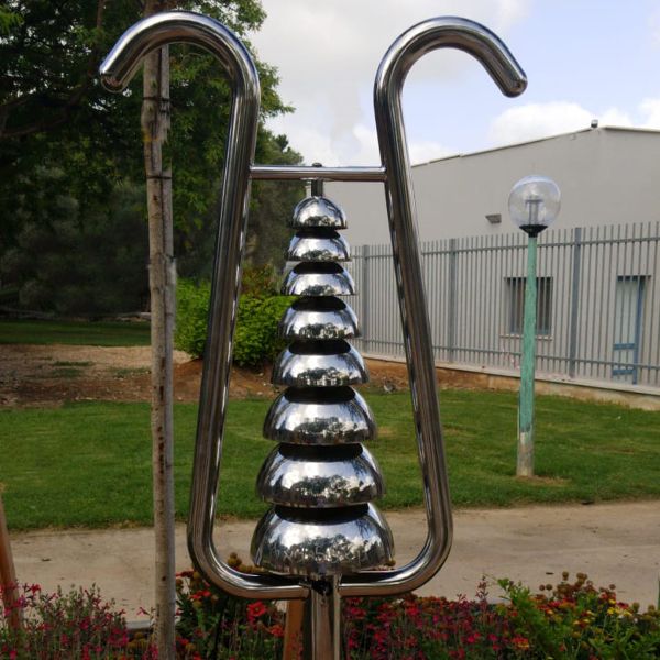 a tall stainless steel outdoor bell lyre in the musical playground at Kibbutz Magal