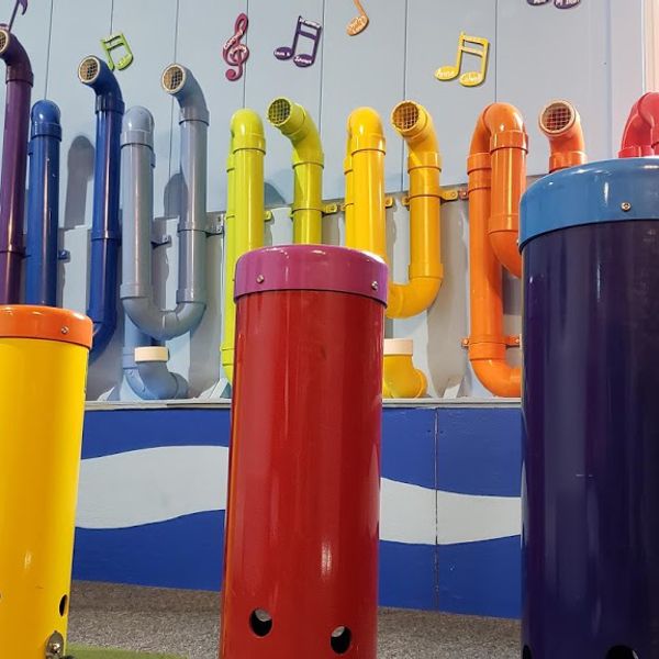 an image of the rainbow coloured outdoor music drums in the cape cod children's museum