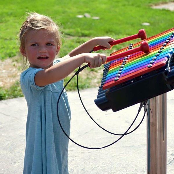 little girl playing a rainbow cavatina xylophone in the st feriole memorial gardens music park