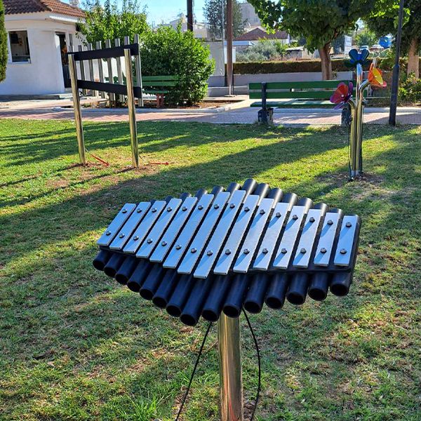 a large silver outdoor xylophone in a park in cyprus