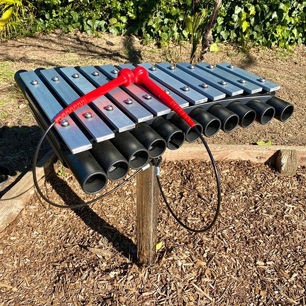 picture of a silver outdoor xylophone in the morgan autism center new musical garden