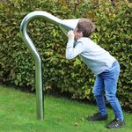 boy speaking into a large stainless steel cone playground talk tube