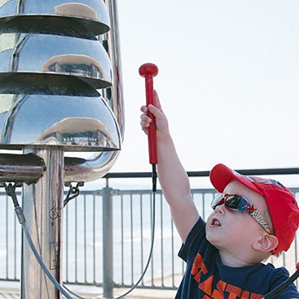 Small Boy in Cap and Sunglasses Playing Large Bell Lyre Outdoor Chime on Boscombe Pier 