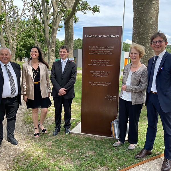 Five people gathered arounds a sign opening the new music garden at Bar-sur-Seine hospital