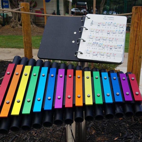 a rainbow coloured outdoor xylophone called a cavatina by percussion play in the musical playground in Kibbutz Magal