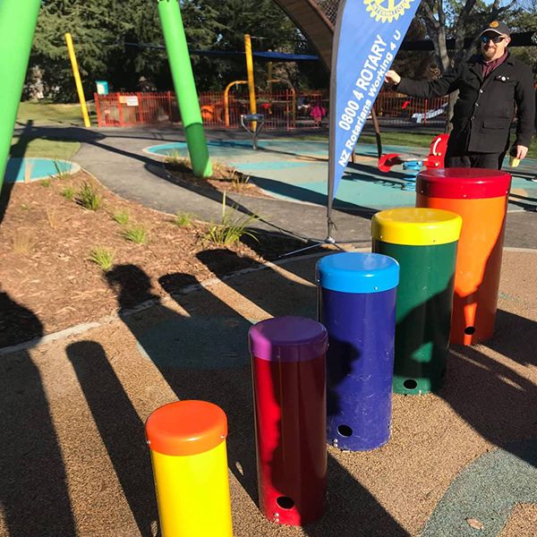 A colourful set of outdoor playground drums in an inclusive playground