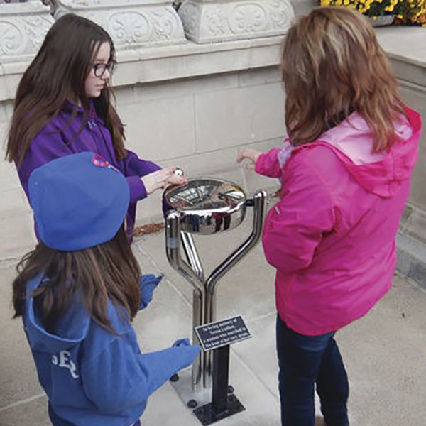 group of young ladies playing the stainless steel tongue drum installed outside La Porte City Hall in Indiana