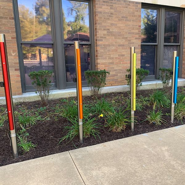 outdoor rainbow coloured chimes in a senior living facility