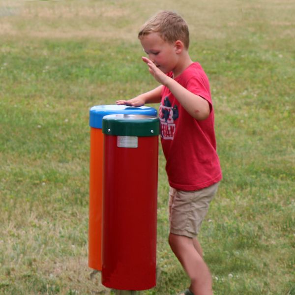 boy playing outdoor drums in new outdoor music area at camp henry 