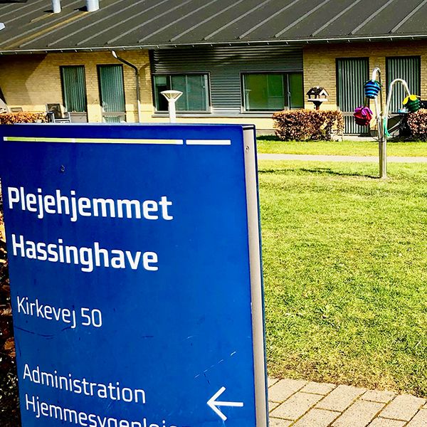 The entrance sign to the Hassinghave Carehome with outdoor musical flowers in the background