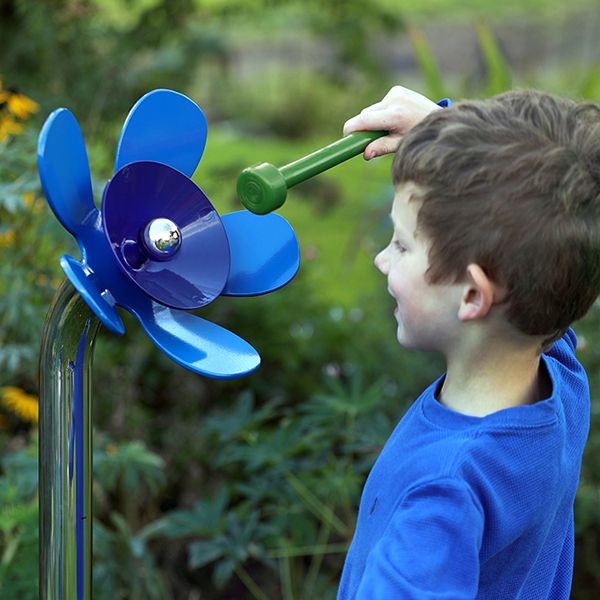 Harmony Flower outdoor musical instrument in blue being played by a young boy