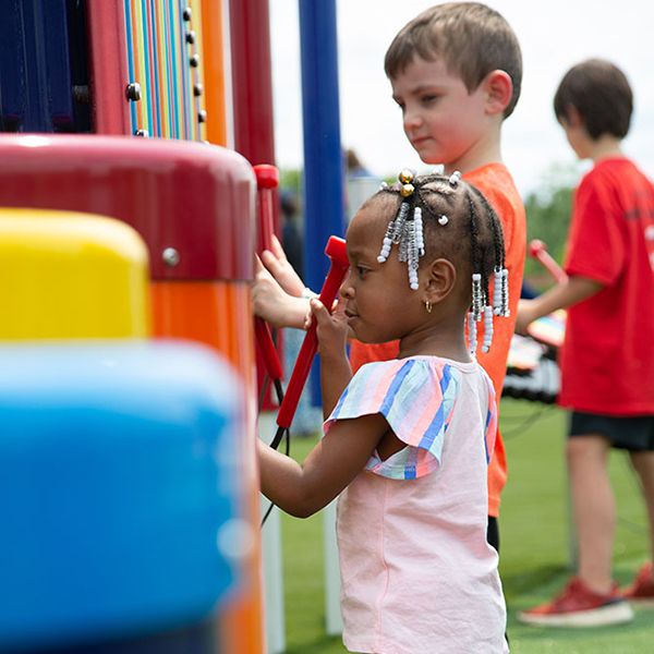 Children playing the outdoor musical instruments in the new playground at the Arc Encounter family attraction