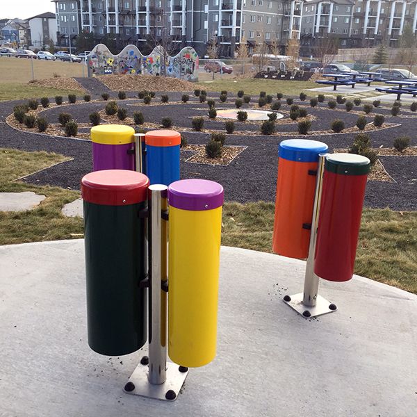 a group of outdoor conga drums outdoor musical instruments in the outdoor classroom at Buffalo Rubbing Stone Elementary School in Canada