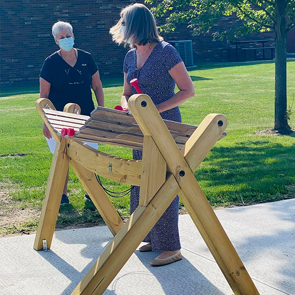 two ladies playing a wooden outdoor marimba in the Bridge to Bay Music Park Michigan